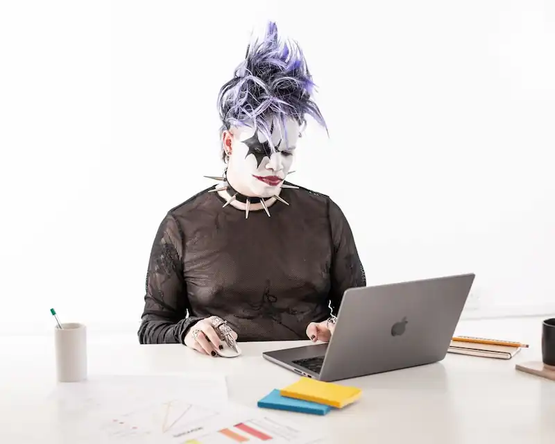 A job applicant writing a professional email response on a laptop